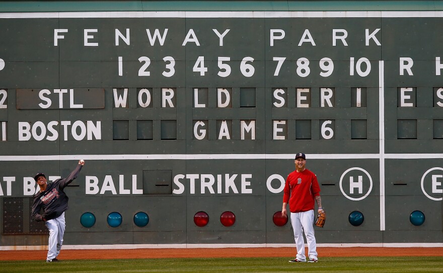 For Game 6, the World Series returns to Boston's Fenway Park, where the home team hasn't clinched a championship since 1918. Here, Red Sox players warm up in front of the Green Monster.
