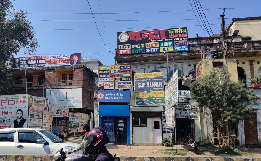 Signs in Prayagraj advertise companies that promise to prep young people for exams for government jobs.