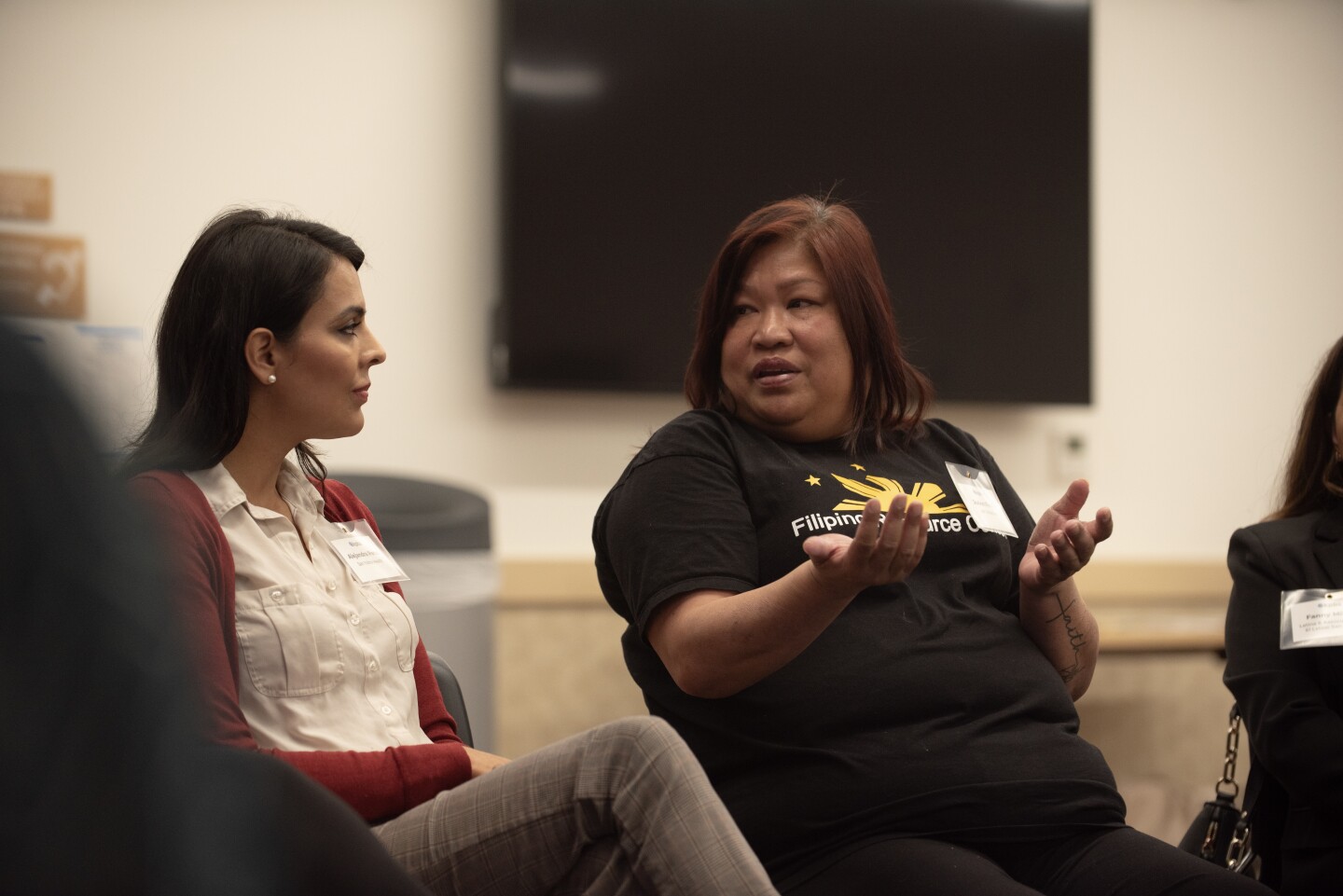 JoAnn Fields (right) discusses with Alejandra Perez (left) and other South Bay community leaders at the San Ysidro library on Tuesday, Feb. 20, 2024.