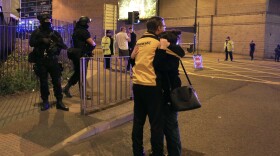 Armed police stand guard at Manchester Arena after reports of an explosion at the venue during an Ariana Grande gig in Manchester, England, May 22, 2017. 