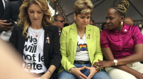 Barbara Poma, from left, owner of Pulse nightclub, Patty Sheehan, city commissioner, and Regina Hill, city commissioner, attend a public remembrance ceremony Monday, June 12, 2017, at Pulse nightclub in Orlando, Fla., in honor of the 49 people who lost their lives in the shooting one year ago.