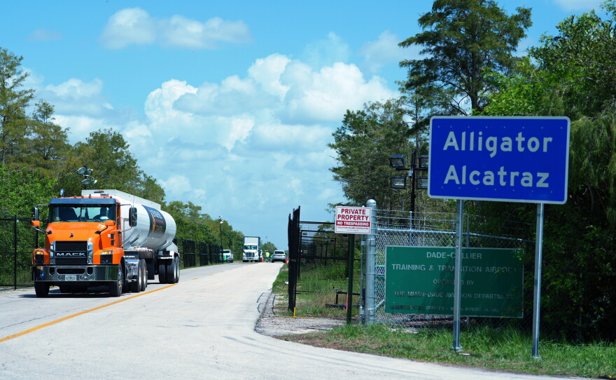 FILE - Trucks come and go from the "Alligator Alcatraz" immigration detention center in the Florida Everglades, Aug. 28, 2025, in Collier County, Fla.