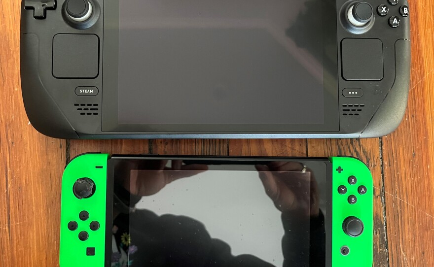 The Steam Deck (top) far outweighs my particularly well-loved Nintendo Switch.