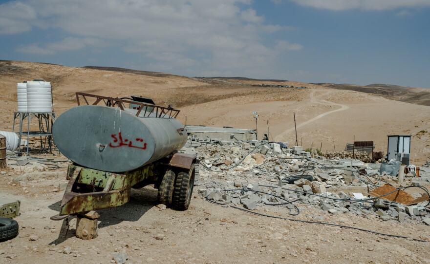 Rubble and concrete debris from the demolished home of Yaser Abu Sabha lie scattered beside a water tank trailer in Masafer Yatta, in the Israeli-occupied West Bank, on Sept. 24, 2026.