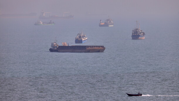 FILE - A small boat sails past cargo ships and other commercial vessels anchored in the Strait of Hormuz off Bandar Abbas, Iran, Wednesday, Aug. 5, 2026. (Amirhosein Khorgooi/ISNA via AP, File)