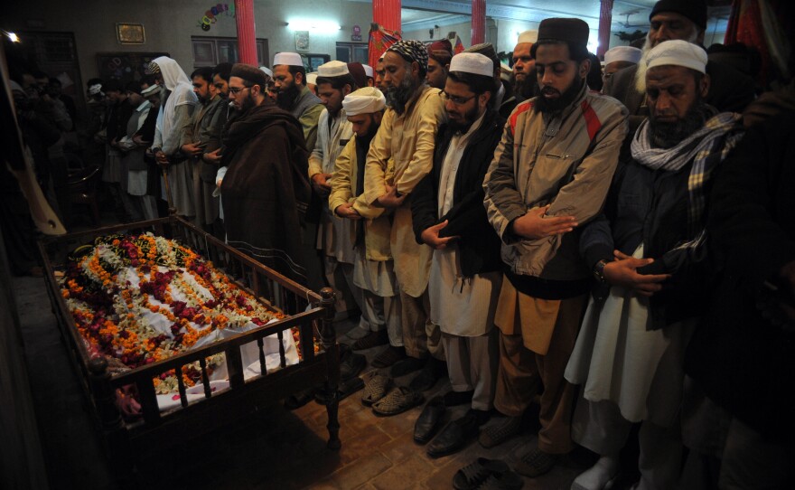Pakistani mourners pray during the funeral of a student following an attack by Taliban gunmen on a school in Peshawar.