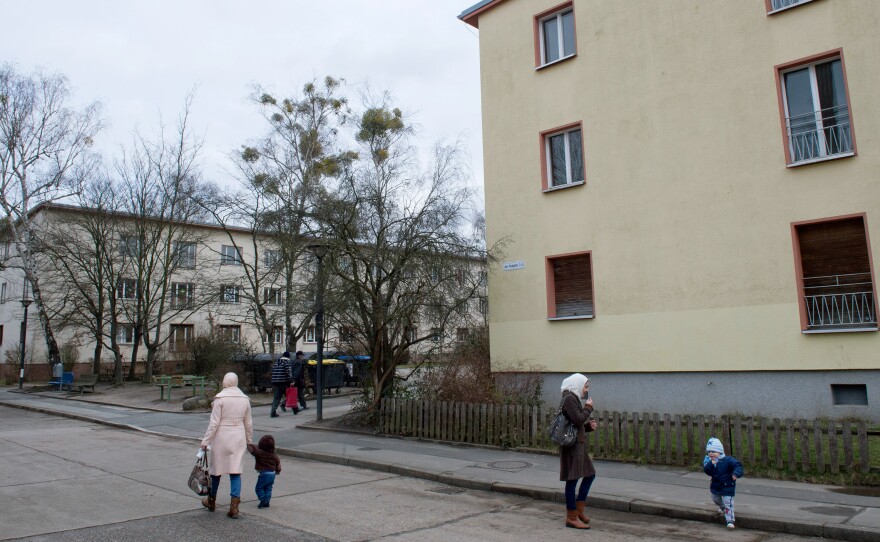 Refugees walk along on a street near the Initial Reception Camp Marienfelde in Berlin, Germany, in January. Marienfelde camp has been a transitional home for refugees in Germany for more than 60 years. But the recent influx of asylum-seekers is straining the system.