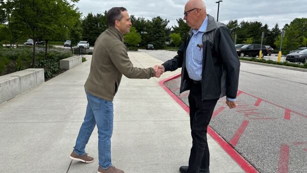 Outside a polling place in West Lafayette, Ind., Republican state Sen. Spencer Deery greets voters arriving for early voting on April 28. Deery is a Republican incumbent President Trump has targeted after he opposed the president's redistricting push in Indiana.