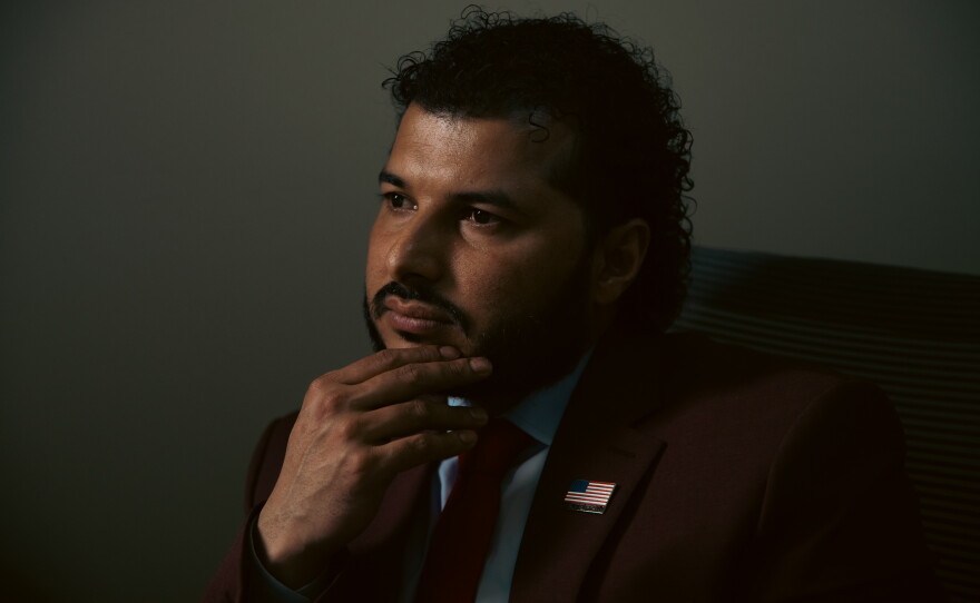 Binay Luitel poses for a portrait in his office in Ghimire Homes real estate brokerage, in Harrisburg, Pa., on April 16, 2025. Luitel, a U.S. Army veteran, works to find homes for members of his community.