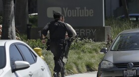 Officers run toward a YouTube office in San Bruno, Calif., Tuesday, April 3, 2018. 