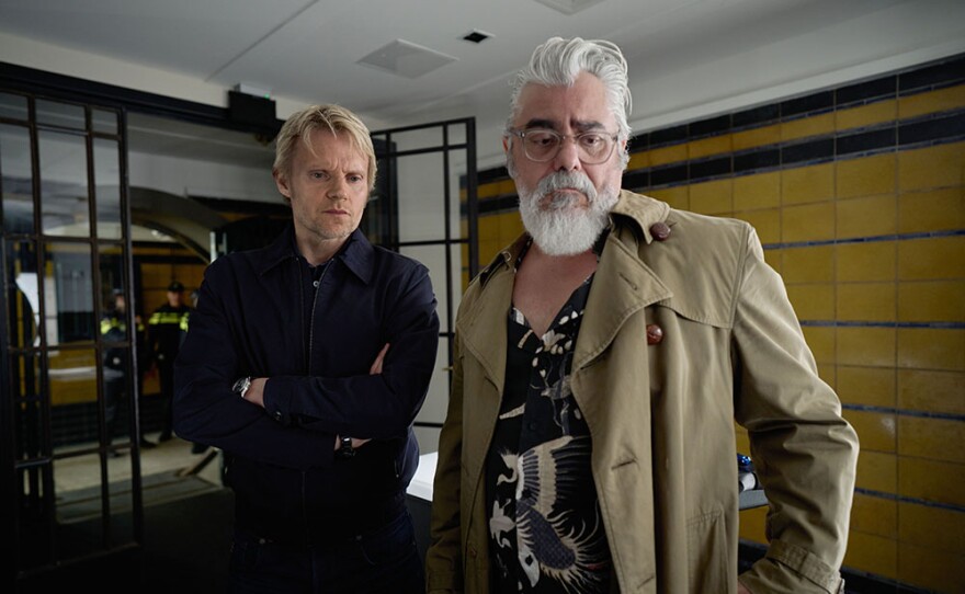 Marc Warren as Piet Van der Valk and Darrel D'Silva as Hendrik Davie in MASTERPIECE VAN DER VALK Season 2.