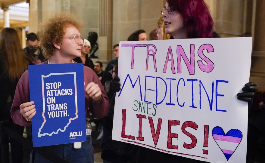 Protesters stand outside of the Senate chamber at the Indiana Statehouse on Feb. 22, 2023, in Indianapolis. Republican Governors in Indiana and Idaho have signed into law bills banning gender-affirming care for minors early April 2023, making those states the latest to prohibit transgender health care this year.