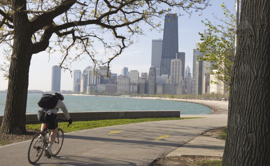 Cyclist by Lake Michigan shore, Gold Coast district, Chicago. Biking to work is associated with higher levels of well-being.