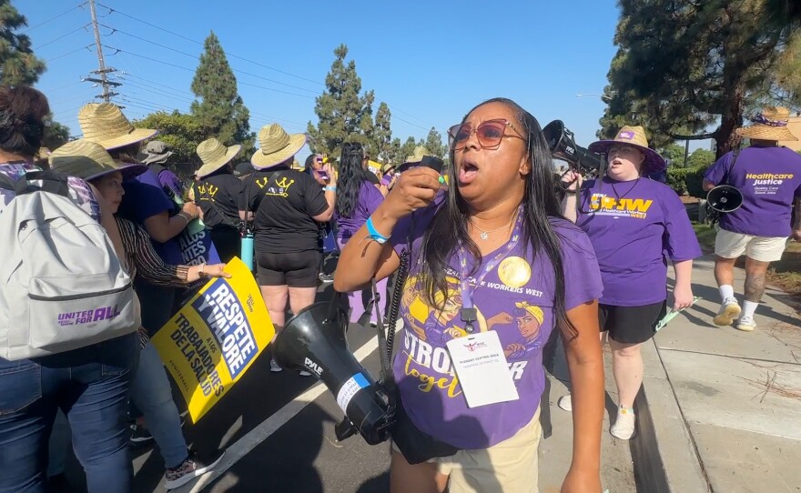 An SEIU protester is shown speaking through a bullhorn at the protest in Kearny Mesa on August 9, 2024.