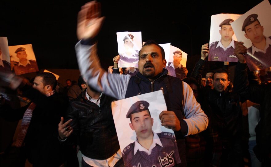 Relatives of Jordanian pilot Lt. Muath al-Kaseasbeh, who was captured by ISIS militants in Syria, protest in front of royal palace in Amman, Jordan, Tuesday. Jordan has suggested it might be willing to hold a prisoner exchange for his release.