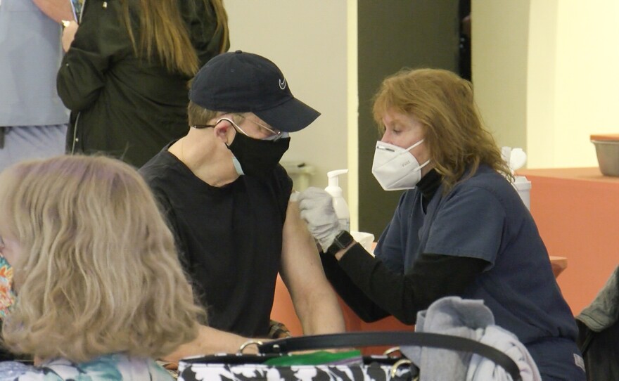 A man receives a COVID-19 vaccine at the vaccination super station at Grossmont Center in La Mesa, Calif. Feb. 2, 2021.