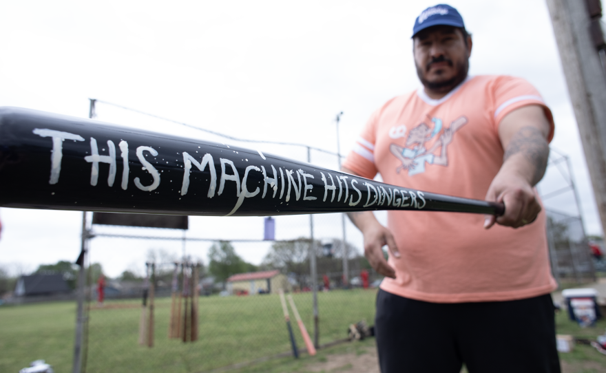 Chris Castro of the Oklahoma City Woodys shows off his bat, a gift from the Jesters, a Tulsa sandlot team.