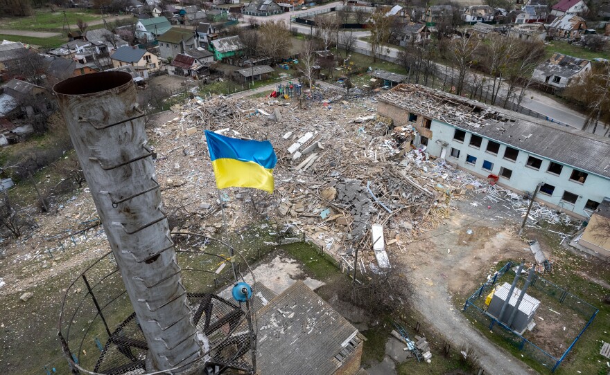 <strong>April 19:</strong> A Ukrainian flag flies over a damaged kindergarten that was bombed in Russia's invasion of Makariv, west of Kyiv. Neighbors said a single bomb struck the school at 5 a.m. on March 7 as Russian forces attacked the town, destroying much of the structure. No one was reported killed in the blast.