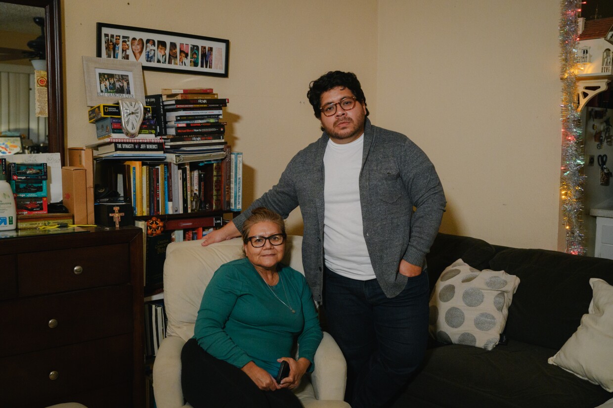 Joshua Lopez, right, stands for a portrait with his mohter, Rosa Perez, at their home at the Hawaiian Gardens apartments in Imperial Beach, California on November 18, 2024. Lopez is one of dozens of tenants facing eviction and is urging the City Council to pass new local protections for renters.