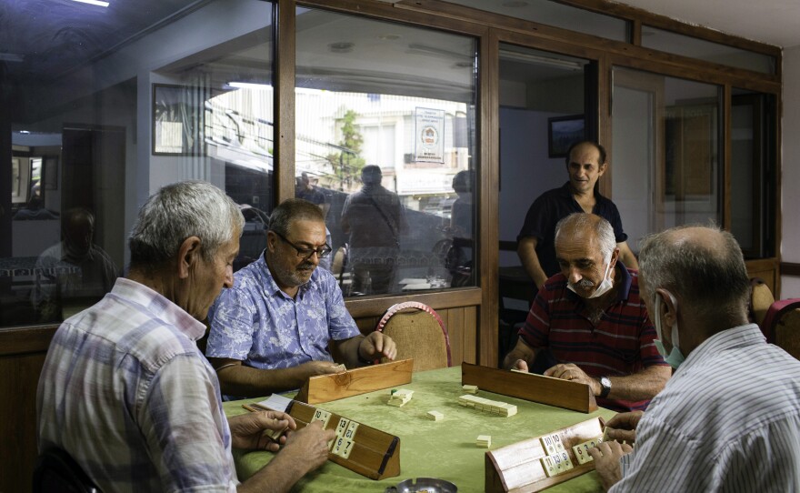 Men are playing a Turkish tile game called Okey in a teahouse in Trabzon. One of them wonders out loud, why wouldn't Afghans stay in their country and fight?