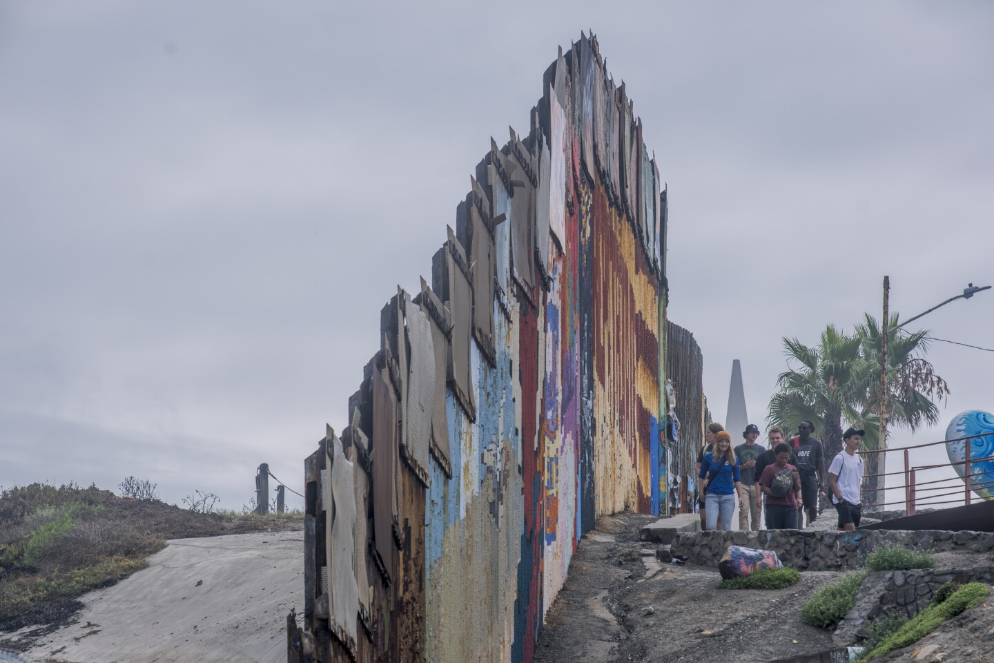 A group of American tourists visits the American-built border wall separating San Diego from Tijuana in Playas de Tijuana, Aug. 21, 2023.