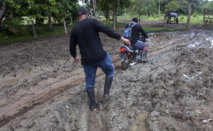 Vivó struggles through mud on his way to a migrant camp called Las Tecas where he will begin the trek into the Darién Jungle.