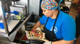 Carne asada fries are made by a worker at Tako Factory off El Cajon Blvd. in the College Area, May 23, 2019.
