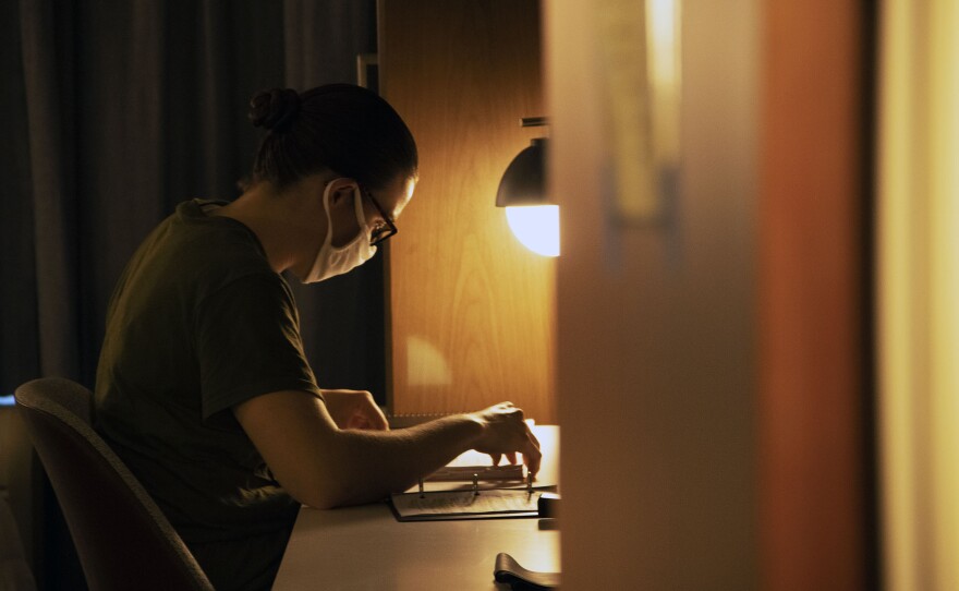 A female Marine recruit goring through her assigned work while under quarantine during the coronavirus pandemic at an undisclosed hotel, Feb. 5, 2021.