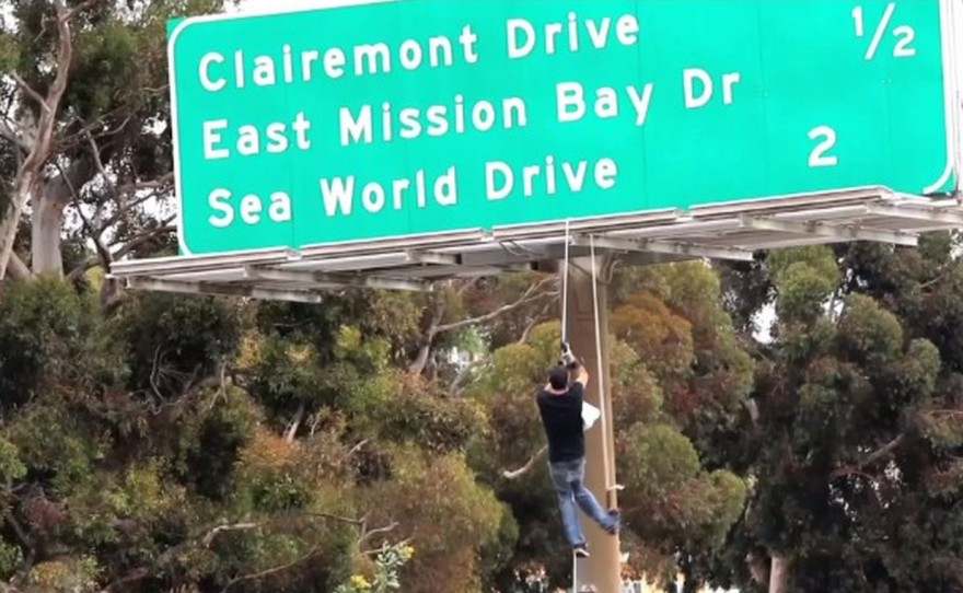 "Jackass" star Steve-0, whose real name is Stephen Gilchrist Glover, attempts to scale a freeway sign along Interstate 5, May 25, 2014.
