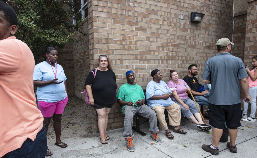 Evacuees sit outside the temporary shelter at Trask Middle School before Hurricane Florence arrives in Wilmington, N.C., on Thursday.
