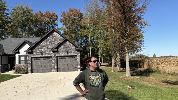 Nick Owens, an attorney in Brown County, Ohio, stands at the edge of a Mt. Orab neighborhood next to farmland that has been sold to a data center developer. Owens is leading an effort to halt the buildout of hyperscale data centers in communities like this one.