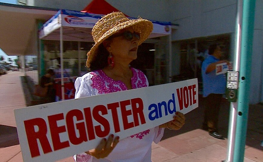 Carmen Lopez, Latino outreach coordinator for the San Diego County Registrar of Voters Office, urges City Heights residents to sign up to vote, Sept. 22, 2015.
