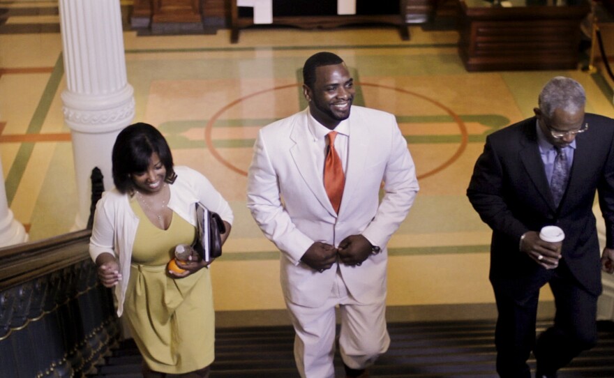 Dallas exonerees Christopher Scott (center) and Richard Miles, accompanied by Scott's girlfriend, Kelly Gindratt, prepare to be honored in the state Capitol in Austin, Texas, in March.