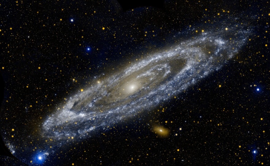 "The Galaxy Next Door" — This composite image of the Andromeda galaxy was produced by NASA's Galaxy Evolution Explorer, showing Andromeda's ultraviolet side. NASA sent a decommission command to the space telescope Friday.