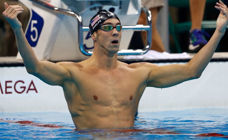 Michael Phelps celebrates winning his 20th gold medal after a razor-thin victory in the men's 200-meter butterfly at Rio's Summer Olympics on Tuesday.