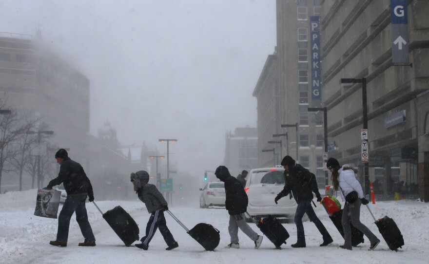 Travelers leave the Back Bay train and subway station in Boston. Dangerously cold temperatures are predicted for the rest of the day.