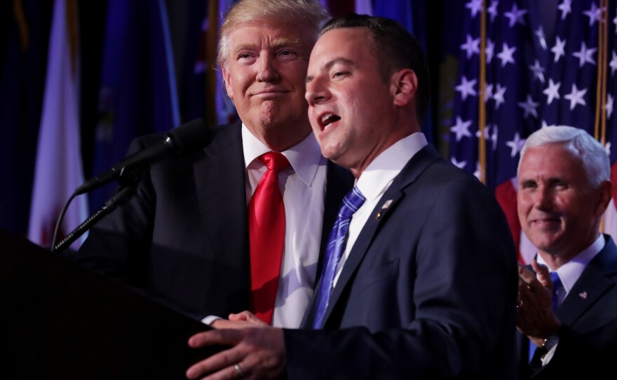 Reince Priebus, chairman of the Republican National Committee, delivers a speech as Republican President-elect Donald Trump looks on during his election night event in New York City.