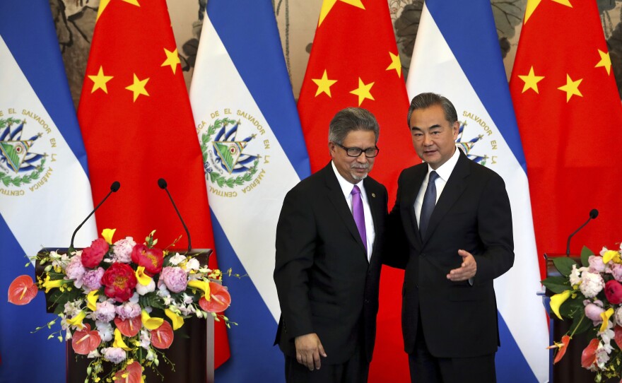 El Salvador's Foreign Minister Carlos Castaneda, left, and China's Foreign Minister Wang Yi stand together at a ceremony in Beijing to mark the beginning of diplomatic relations between the two countries on Tuesday. The move leaves Taiwan with one less ally.