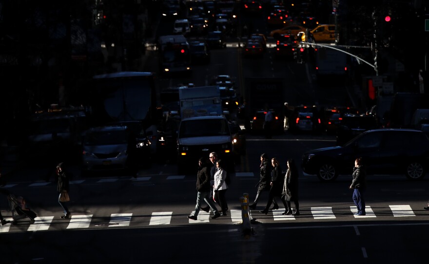 Pedestrians cross the street as traffic moves along 42nd Street in Midtown Manhattan on Jan. 25.