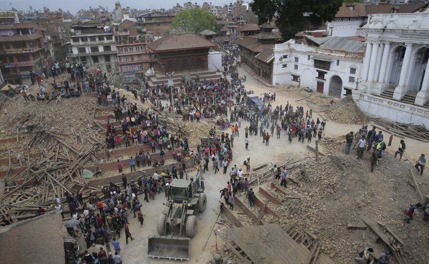 People search for survivors under the rubble of collapsed buildings in Kathmandu Durbar Square on Saturday.
