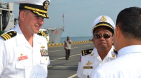 Cmdr. Joseph R. Darlak, commanding officer, USS Vandegrift (FFG 48), communicates with Royal Cambodian Navy Rear Adm. Ros Veasna, deputy commander of Maritime Base via translator about Cooperation Afloat Readiness and Training (CARAT) Cambodia phase 2012. 