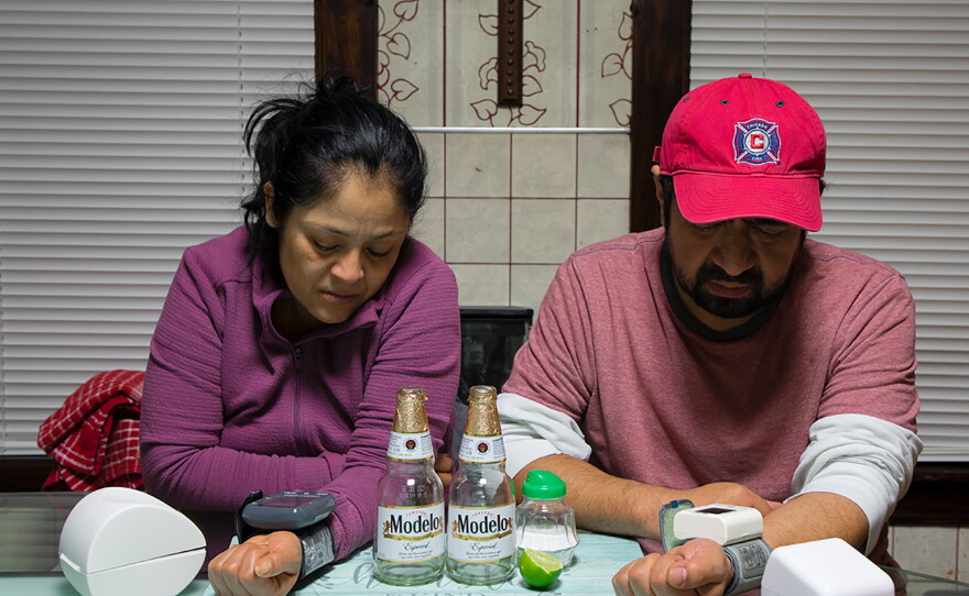 Nelly and Mario Villanueva check their blood pressure after dinner in 2021.