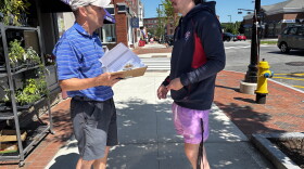Maine Senate hopeful, Democrat David Costello, speaks with a potential voter as he gathers signatures, required to be considered at the party's convention, in downtown Brunswick, Maine on July 12.