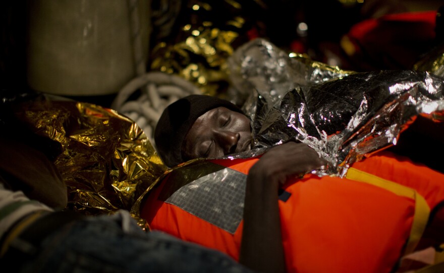 A refugee from Eritrea rests on a ship operated by the Italian navy after being rescued from the Mediterranean sea, about 13 miles north of Sabratha, Libya, on Monday.