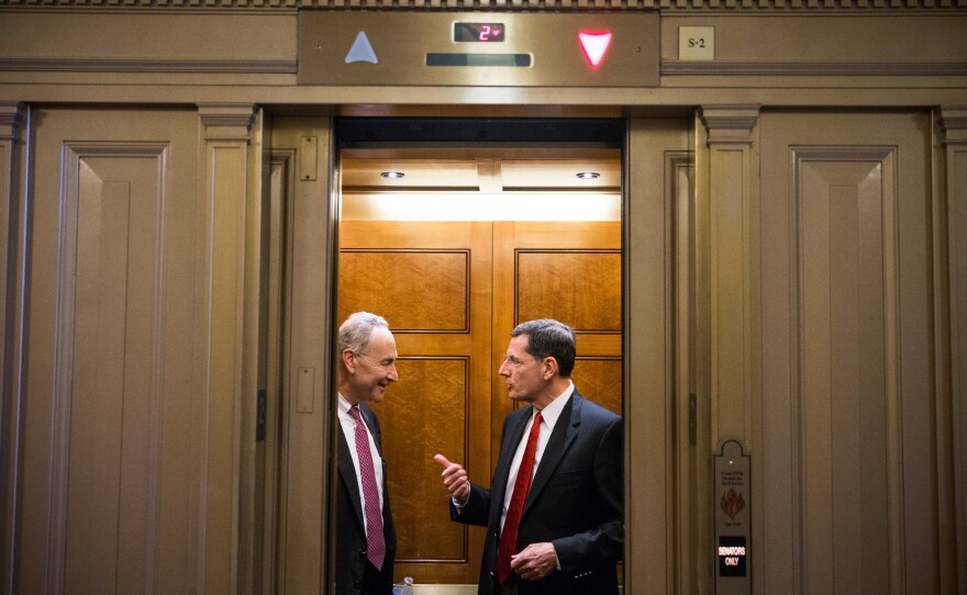 Sen. Chuck Schumer (D-NY), left, seen here speaking with Sen. John Barrasso (R-WY) in an elevator Sunday, says that undoing the sequester cuts is "one of the sticking points" in budget talks. Congress is struggling to find a solution to end the government shutdown, now in its thirteenth day.