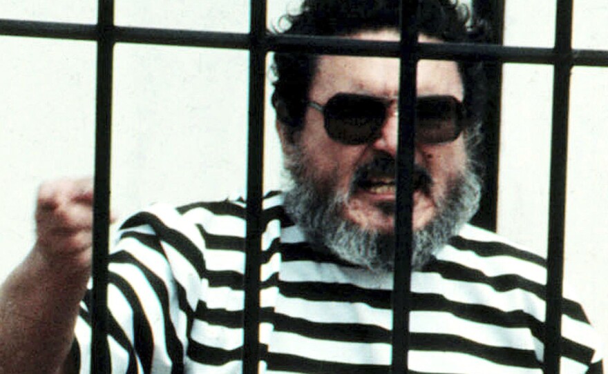 In this Sept. 1992 file photo, Abimael Guzmán, the founder and leader of the Shining Path guerrilla movement, shouts inside of a jail cell after being captured in Lima, Peru. The Peruvian government reported Saturday that Guzman died after an illness.