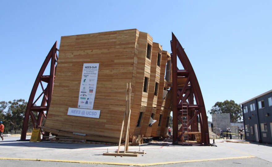 Collapsed wood frame soft story test building on the UCSD NEES shake table.