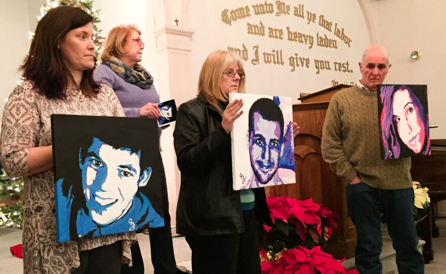 Amanda Jordan, Diane Yelle and Jim Zanfagna hold portraits of their children killed by overdoses at a service for families affected by addiction at the First Baptist Church of Plaistow on Dec. 20, in Plaistow, N.H. Anne Marie Zanfagna stands in the back.