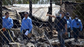 Forensics work among the rubble of a nursing home after it caught fire in Mexicali, Mexico, June 23, 2015. 