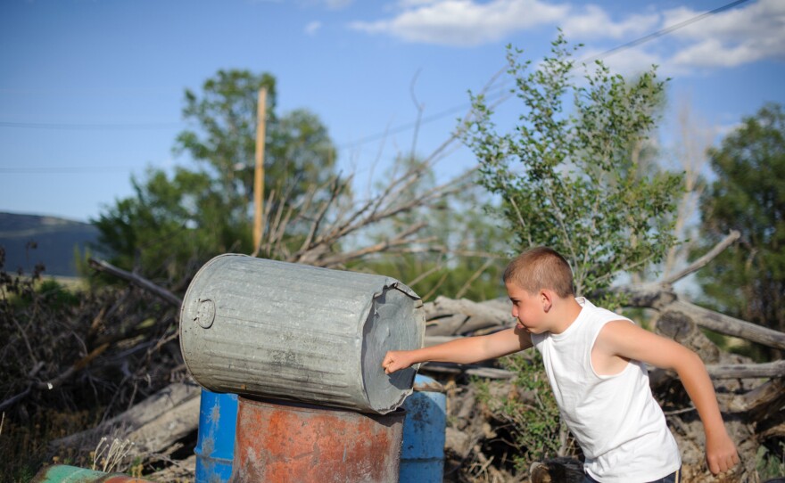 Vinny punches a trashcan behind his aunt's home in northern New Mexico. Juvenile Court ordered that he live with his paternal aunt after his release from juvenile detention. He was incarcerated at age 13 for stabbing his mother's assailant.